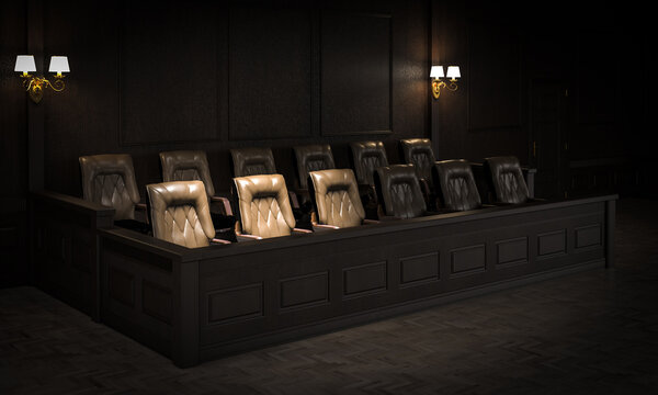 Empty jury box in dark courtroom awaiting jury members