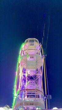 Cinematic Shoot Of ferris wheel or "Bianglala" at night markets in Bireuen, Indonesia as a game for residents and children
