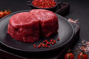 Fresh juicy raw beef medallions with salt and spices