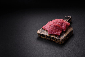 Juicy fresh raw beef meat with salt, spices and herbs