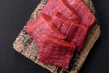 Juicy fresh raw beef meat with salt, spices and herbs