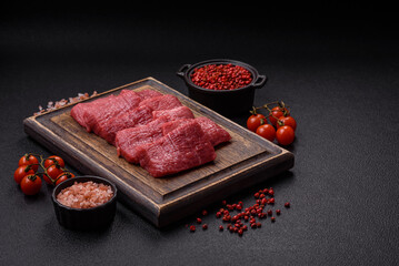 Juicy fresh raw beef meat with salt, spices and herbs