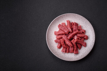 Juicy fresh raw beef meat with salt, spices and herbs