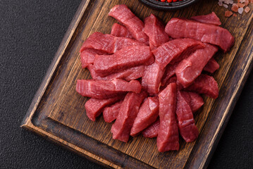 Juicy fresh raw beef meat with salt, spices and herbs