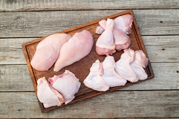 Raw mixed chicken meat parts  for cooking on rustic background