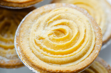 A pastry with a swirl of frosting on top