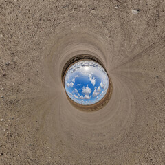 blue hole sphere or globe little planet inside sand or dry ground frame background with tractor...