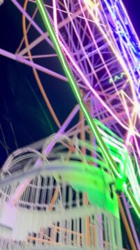Cinematic Shoot Of ferris wheel or "Bianglala" at night markets in Bireuen, Indonesia as a game for residents and children