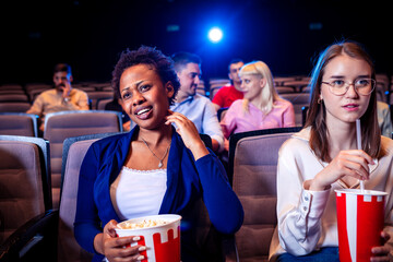 African American woman is watching movie in the cinema.