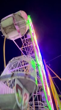 Cinematic Shoot Of ferris wheel or "Bianglala" at night markets in Bireuen, Indonesia as a game for residents and children