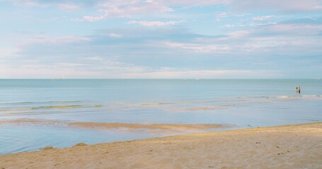 A tranquil beach with gentle waves and a pastel sky at sunset, perfect for relaxation and travel themes.