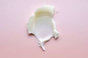 Texture of cosmetic butter on a pink background. Showcasing a thick and nourishing texture.