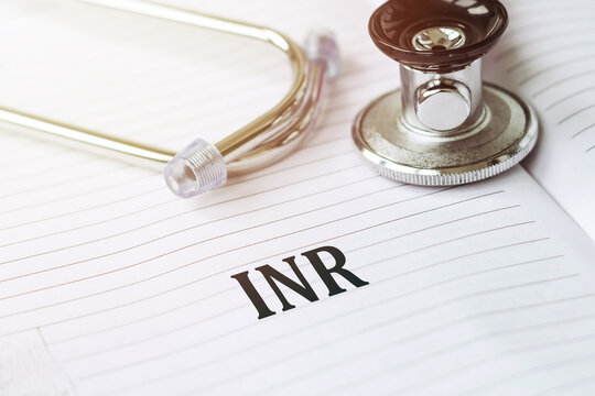 Stethoscope and Notebook With INR Written on a Page