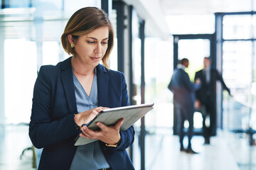 Business woman, internet and tablet for reading email, communication and networking in office....