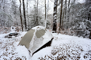 Winter camping with a tent in the snow