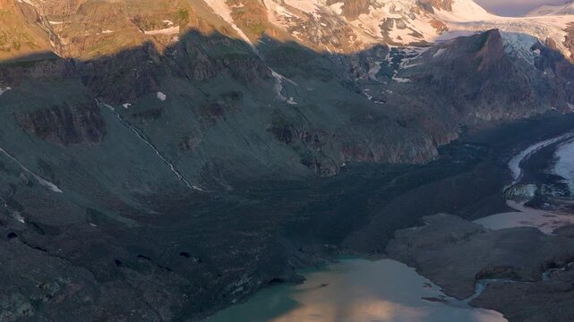Early morning sunlight falls on snowy peaks. Grossglockner Mountain.  Eternal Pastertse glacier. Austria.