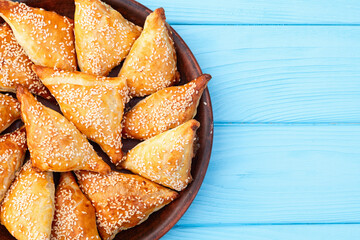 Homemade triangle puff pastry with meat on rustic background . Samosa