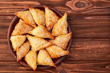 Homemade triangle puff pastry with meat on rustic background . Samosa