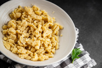 spaetzle egg pasta irregular shape fresh meal food snack on the table copy space food background rustic top view