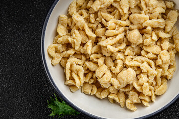 spaetzle egg pasta irregular shape fresh meal food snack on the table copy space food background rustic top view