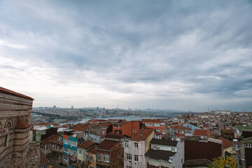 Panoramic view of Istanbul highlights a striking contrast between old weathered rooftops and modern...