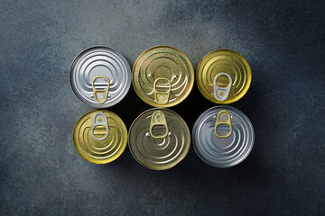 Aluminum cans with canned goods. A large set of canned goods in cans. On a gray background.