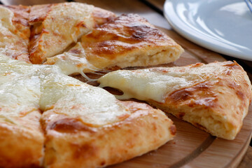 traditional Georgian bread with cheese known as imeruli khachapuri plate in close up on table