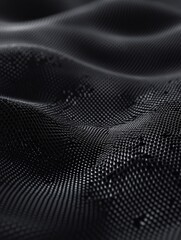 Textured black fabric with ripples under soft light