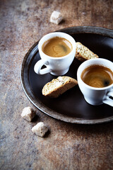 Two Cups Of Coffee on rustic stone background.