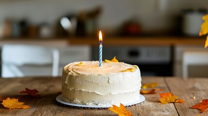 A birthday cake with a lit candle on top of it