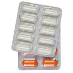 a blister pack of white pills lying on a pack of red pills
