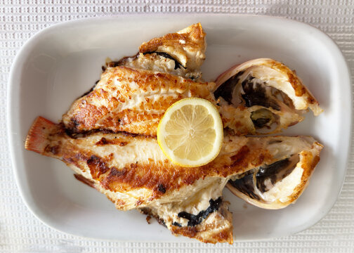 Overhead view of a Plate of fresh fish (boca negra) in a white dish
