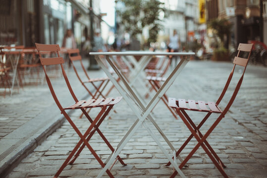 Close-up of cafe chairs and tables in a city street, Brussels, Belgium