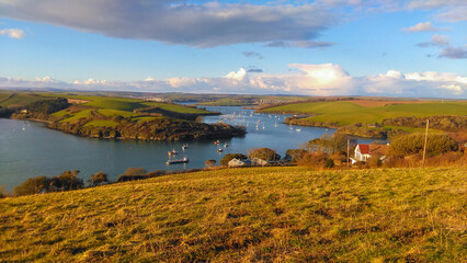 Salcombe Estuary landscape with sailing in the evening sunset 