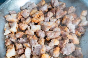 Pieces of pork are fried in a pan. Recipe.