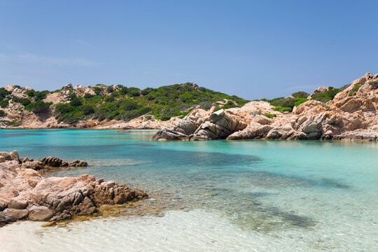 View from shore across the calm turquoise waters of Cala Napoletana, Caprera Island, La Maddalena Archipelago National Park, Sassari, Sardinia, Italy, Mediterranean