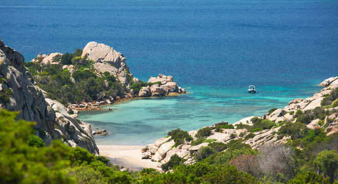 View from rocky hillside over the calm turquoise waters of Cala Napoletana, Caprera Island, La Maddalena Archipelago National Park, Sassari, Sardinia, Italy, Mediterranean