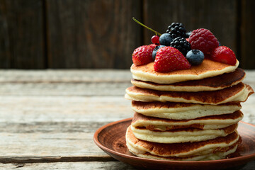 Stack of homemade american pancakes with berries . Top view