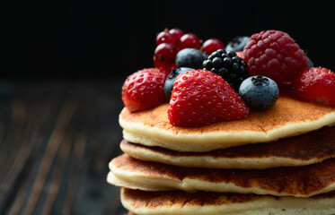 Stack of homemade american pancakes with berries . Top view