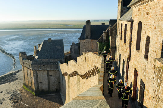 Firemen in training on the ramparts of Mont-Saint-Michel, Manche department, Normandy region, France