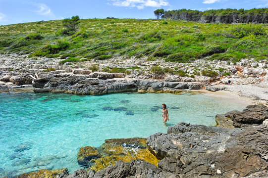 Woman swimming at the small beach of Perna inlet, Palmizana, St. Clement island, Hell's Islands (Pakleni), Hvar city, Hvar island, Croatia, Southeast Europe
