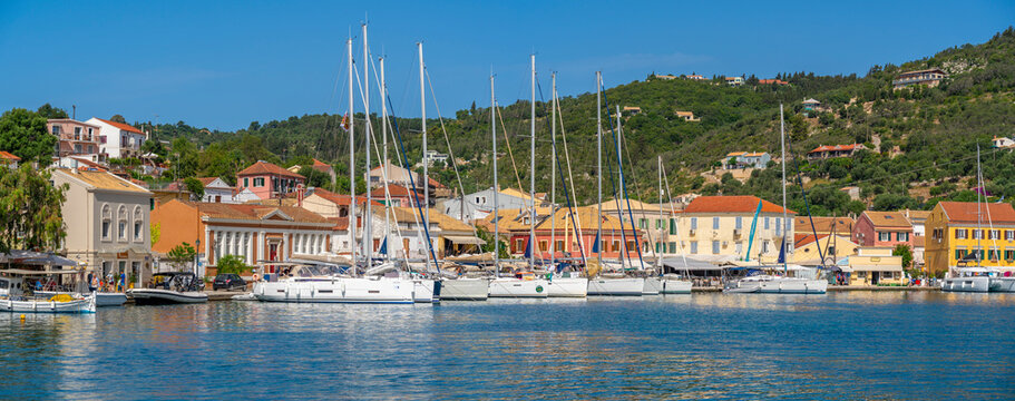View of boats and colourful buildings in the harbour in Gaios Town, Paxos, Ionian Sea, Greek Islands, Greece