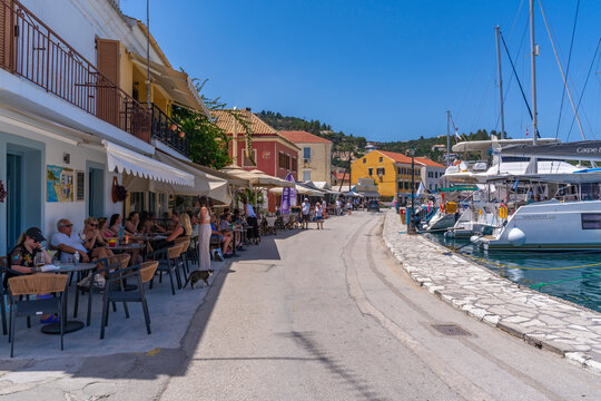 View of boats and cafes in the harbour in Gaios Town, Paxos, Ionian Sea, Greek Islands, Greece