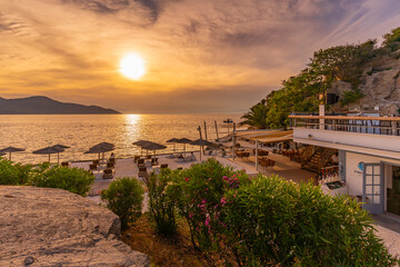 View of beach bar and sea at sunset in Thassos Town, Thassos, Aegean Sea, Greek Islands, Greece