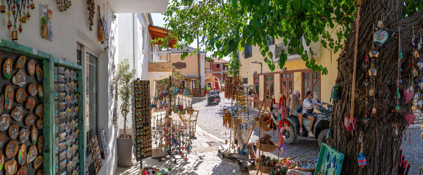 View of souvenir shop and couple on quad bike in Theologos, Theologos, Thassos, Aegean Sea, Greek Islands, Greece
