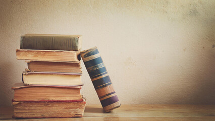 Stack of Well-Worn Vintage Antique Books on a Hardwood Floor with Copyspace