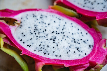 Pitaya or dragon fruit, cut on a marble surface