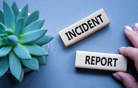 Incident Report symbol. Concept word Incident Report on wooden blocks. Beautiful grey background with succulent plant. Business and Incident Report concept. Copy space
