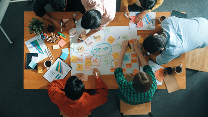 Group of business people writing and making mind map to brainstorming marketing idea at meeting....