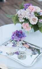 Engagement tray with scissors and rings is decorated with colorful flowers on the table. Engagement ceremony